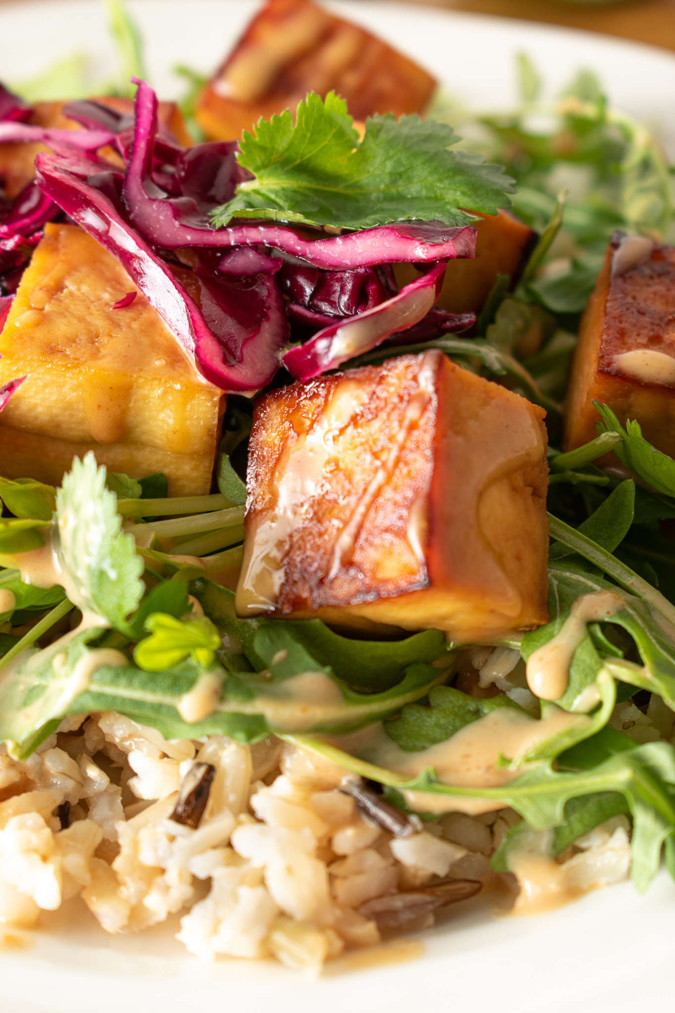 Peanut Sauce Baked Tofu on Rice with Greens and pickled cabbage