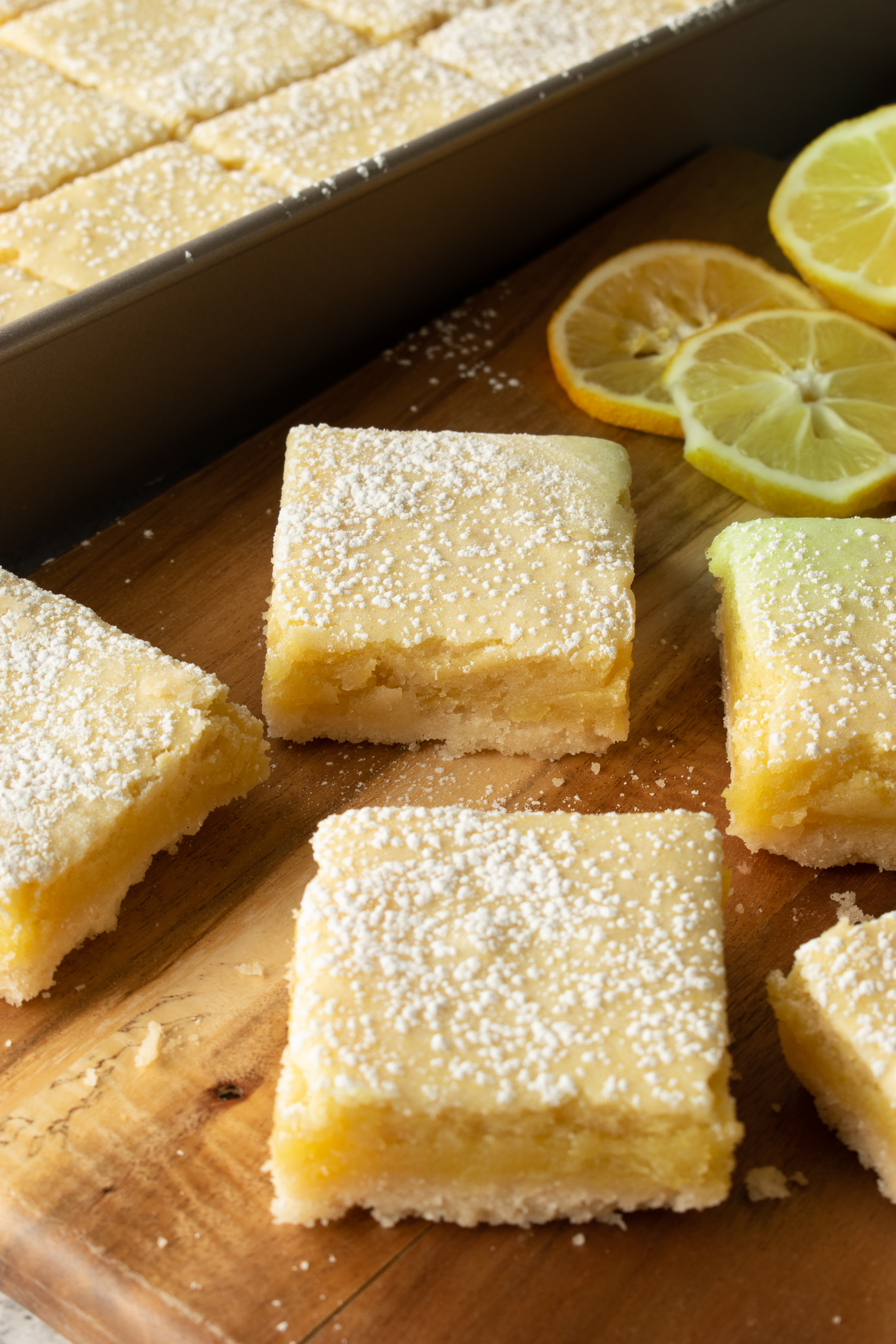 Vegan Lemon Squares with a shortbread cookie layer, topped with icing sugar