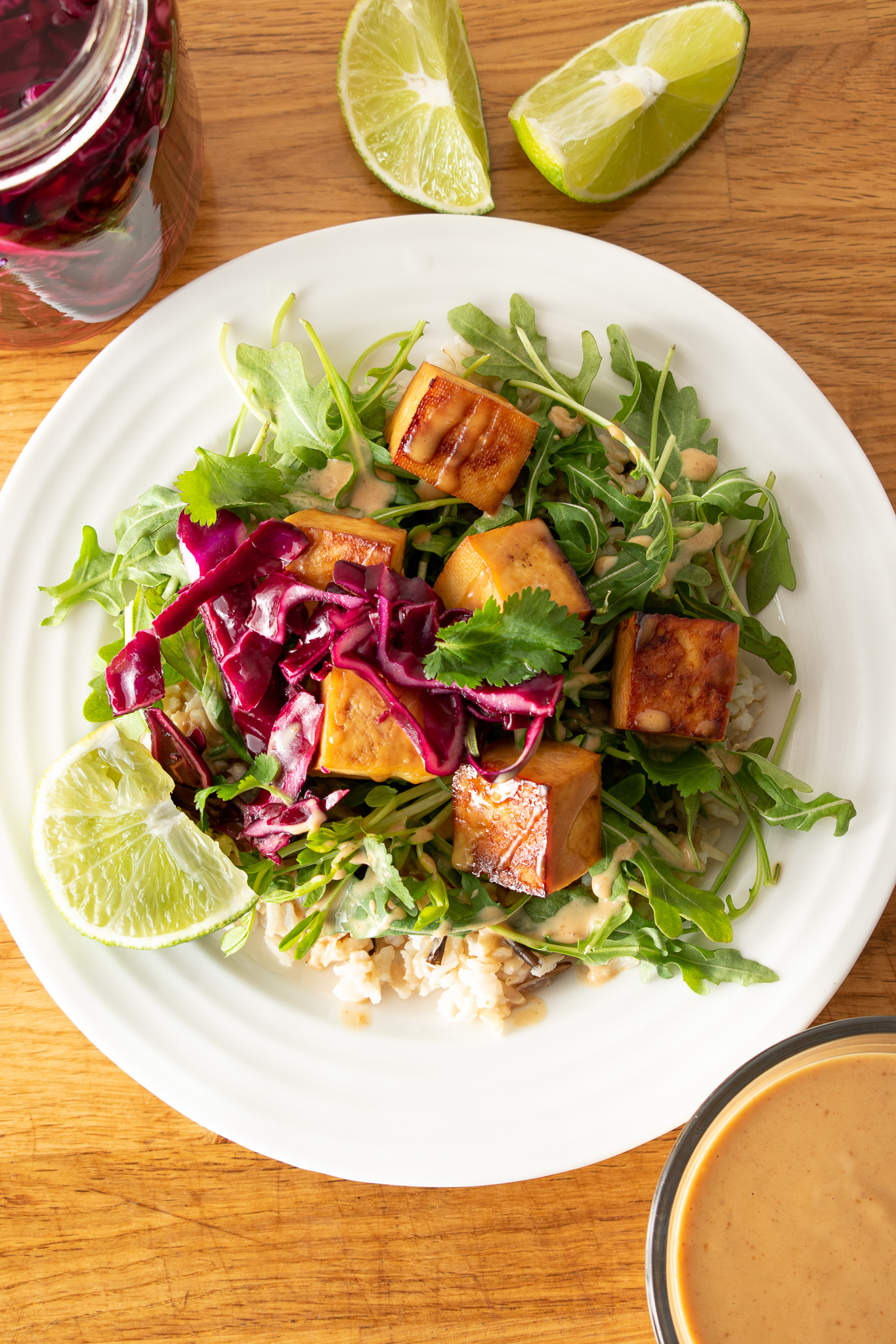 Peanut Sauce Baked Tofu on Rice with Greens and pickled cabbage